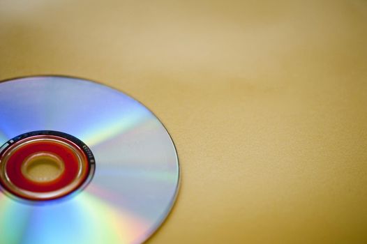 an audio compact disc on a yellow backdrop