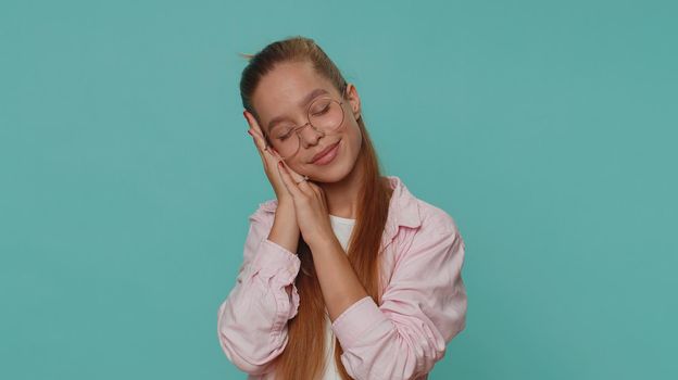 Tired overworked teenager young girl yawning, sleepy inattentive feeling somnolent lazy bored gaping suffering from lack of sleep. Bored student child kid isolated on blue studio background indoors
