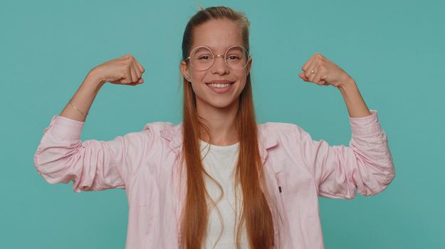 I am strong and independent. Pretty teenager young girl showing biceps and looking confident, feeling power strength to fight for rights, energy to gain success win. Fit sporty student child kid