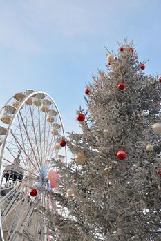 Ferris wheel with fir-tree in France.