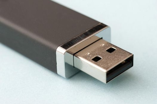 USB flash memory computer stick open to display the universal connector in a close up view on white