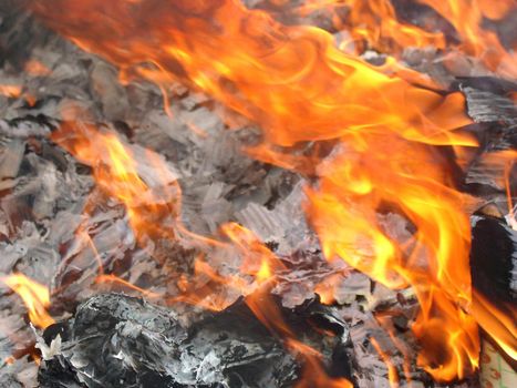 Orange flames licking across burning rubbish as a means of keeping the environment clean and free of waste pollution