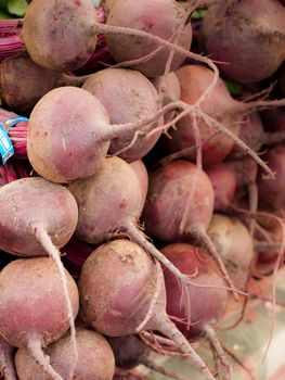 Red beets for sale at a farmer's market.