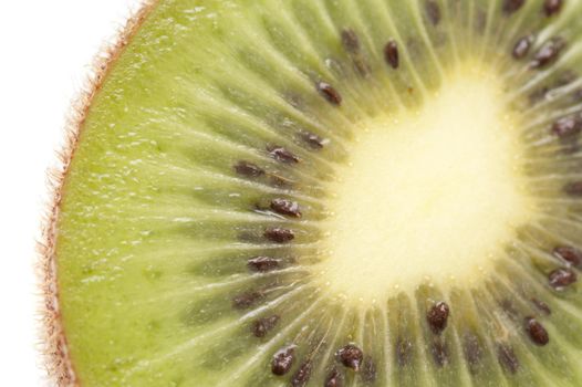 Close up texture of a fresh sliced kiwifruit showing the succulent sweet juicy flesh and pattern of pips