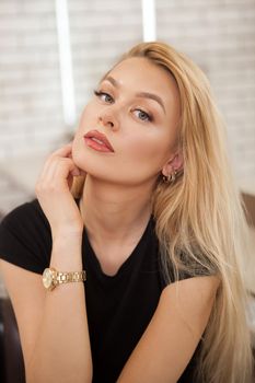 Vertical portrait of a beautiful woman with professional natural makeup looking to the camera