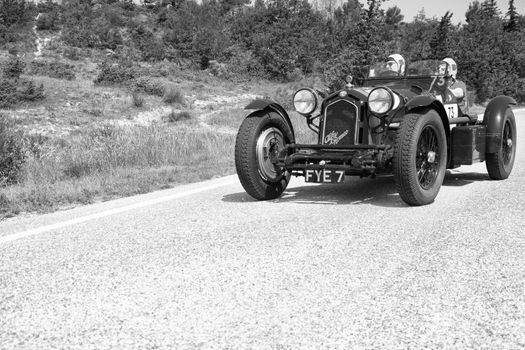 URBINO - ITALY - JUN 16 - 2022 : ALFA ROMEO 8C 2300 MONZA 1933 on an old racing car in rally Mille Miglia 2022 the famous italian historical race (1927-1957