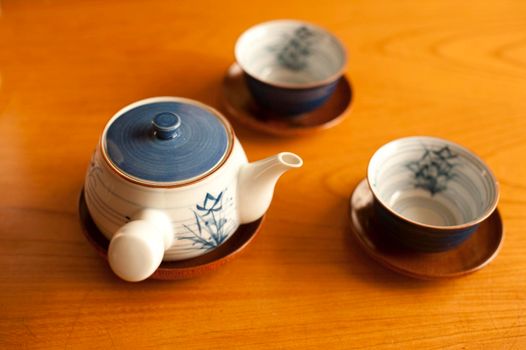 japanese teapot and cups in a wooden table