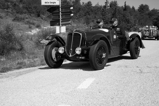 URBINO - ITALY - JUN 16 - 2022 : DELAHAYE 135 CS 1936 on an old racing car in rally Mille Miglia 2022 the famous italian historical race (1927-1957