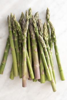 Bunch of raw fresh green asparagus spears, shoots or tips a delicious spring delicacy on a white background
