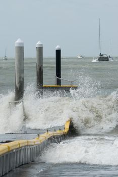storm force winds and waves wrecking a floating pontoon jetty