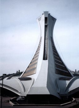 Montreal Olympic stadium tower viewed from the back from low angle against grey sky. Quebec, Canada