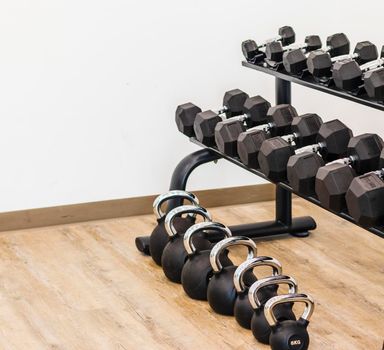 Close up shot of various gym equipment and weights.