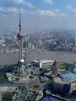 High Angle View of Oriental Pearl TV Tower on Lujiazui with View of Huangpu River and Sprawling Metropolis of Shanghai, China Under Sunny Blue Sky