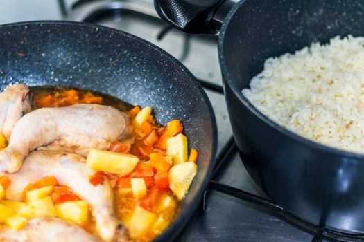 Close up shot of a chicken and vegetable stew and white rice