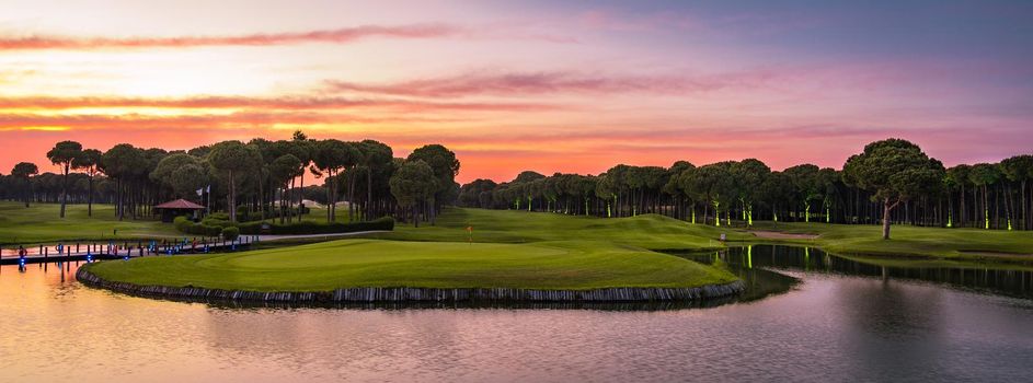 Golf course panorama at dramatic sunset with beautiful sky