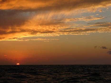 a sunset lilluminating the sky golden orange in color