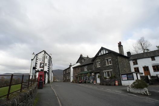 Quaint historical local English pub in a rural village street surrounded by lush countryside and hills for a relaxing venue for an evening drink or midday meal