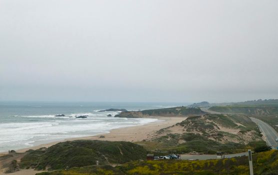sandy coastal dunes on the side of the pacific coast highway