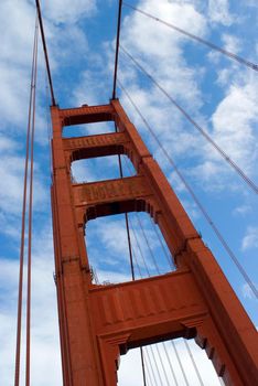 low angle view looking up at one of the distinctive red steel towers supporting the golden gate bridge, san francisco