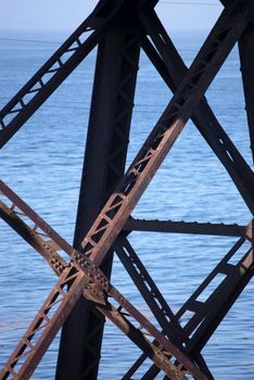close up on the sutructure of a steel trestle railway bridge
