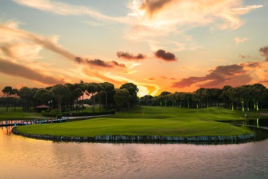 Sunset at the golf course. Scenic panoramic view of a golf fairway