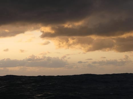 sunbeams streaming from behind a storm cloud