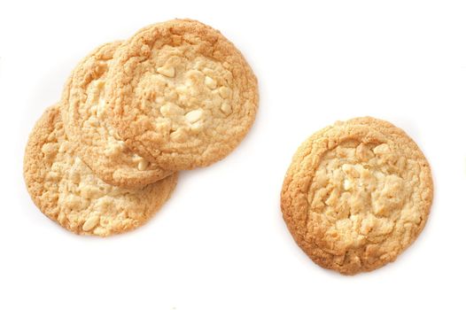 Round golden crunchy biscuits made with oats ready for a tea or coffee break isolated on white