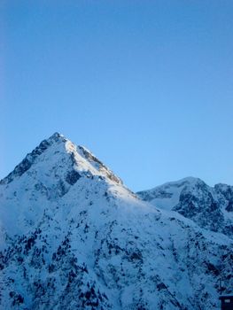 an alpine scene, snow covered mountains in france