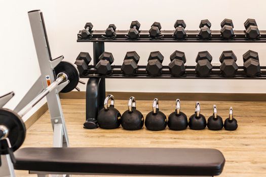 Close up shot of various gym equipment and weights.