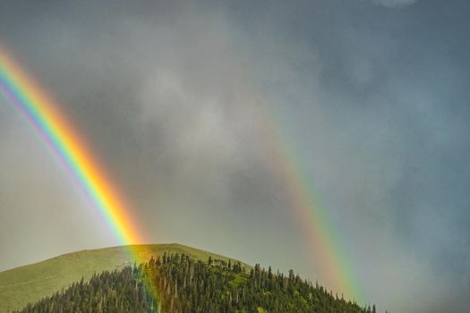 Dramatic sky and rainbow after the rain over the mountains in Georgia