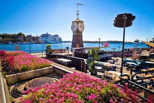 Scenic harbor of Oslo in Aker Brygge with clock tower view, capital city of Norway