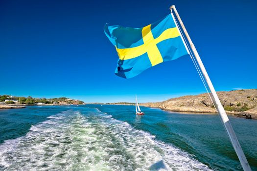 Swedish flag on the boat in Gothenburg islands archipelago, Vastra Gotaland County, Sweden