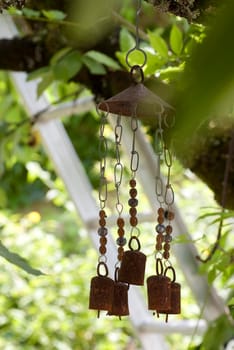 decoraive wind chimes hanging in a garden