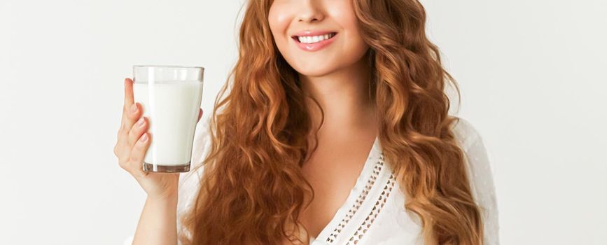 Diet, health and wellness concept, woman holding glass of milk or protein shake cocktail