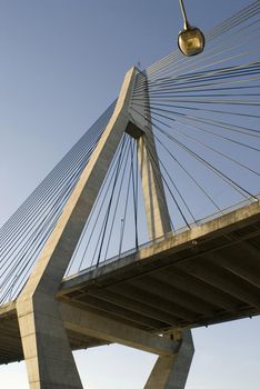 A cable stay suspension bridge tower and wires seen from below at ground level