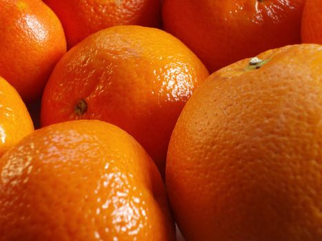 a bowl of ripe oranges sgowing the details of citrus fruit skin
