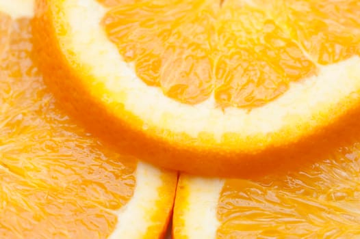 Fresh orange slices showing detail of the juicy pulp and rind prepared as a colourful garnish or salad ingredient