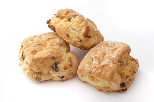 Close Up of Three Freshly Baked Fruit Scones Piled on White Studio Background