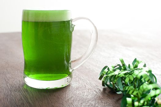 a large glass of green coloured beer to celebrate st. patricks day