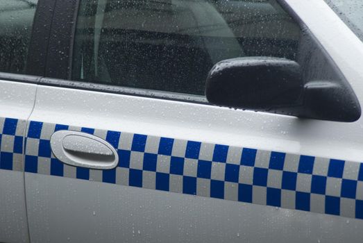 Blue and white chequered markings on a police van used as a means of identifying vehicle used in law enforcement