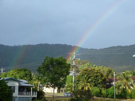 rainbows colour the sky after a passing tropical downpour, north queensland, australia