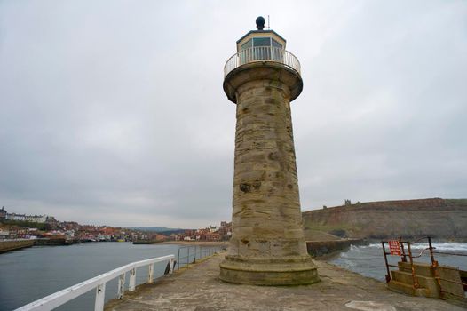 A navigation lighthouse on a stone pier