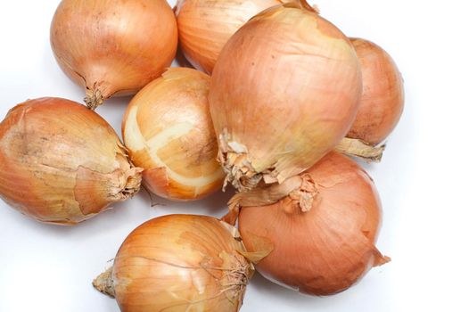 Pile of fresh whole raw brown onions, a pungent aromatic vegetable used in cooking as a flavouring