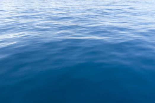 Background texture of the surface of blue sea water with ripples and reflections of sunlight for nautical or marine themed concepts