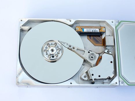 Close up Physical Interior Components of a Computer Hard Disk on a White Background. Captured in Aerial View.