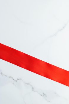 Holiday decor, feminine design and flatlay concept - Red silk ribbon on marble, top view