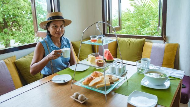 Luxury breakfast in the morning on a table, top view of breakfast in a luxury restaurant in Thailand. Asian women having breakfast