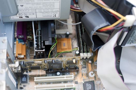 Various types of ribbons, RAM chips and video card assembled inside an open computer case