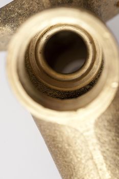 Close up detail of a tap seat or screw fitting on a brass garden tap from overhead