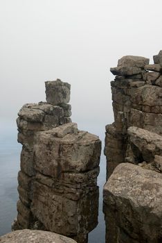 free standing rock formations perched high on the cliffs of cape pillar, tasmania